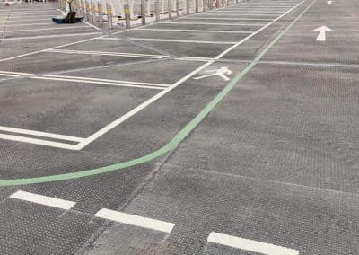 Freshly painted car park lining with pedestrian walkway and directional arrows at a retail shopping centre, completed by Bournemouth White Lining for professional car park lining services