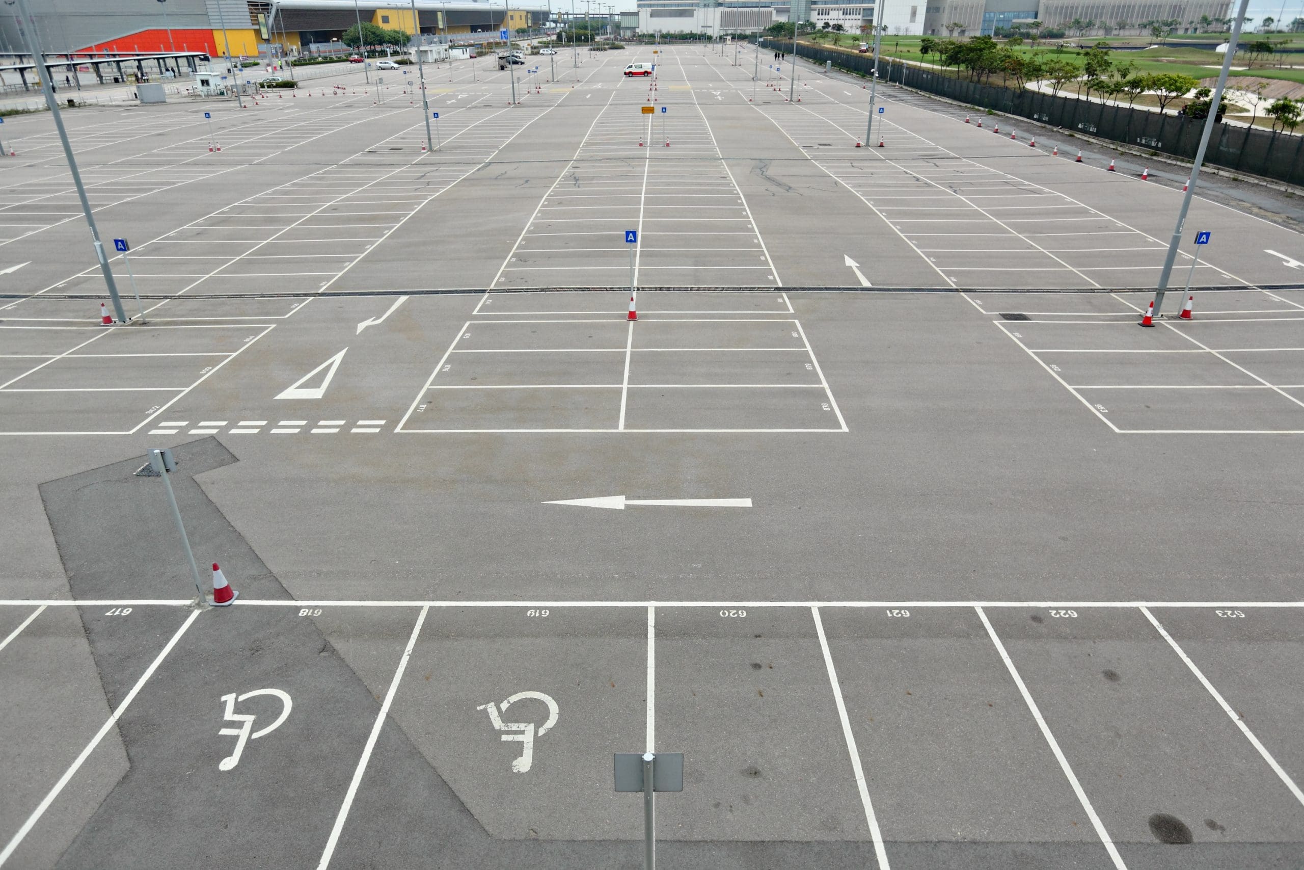 Freshly painted white lines marking parking bays, disabled spaces, and directional arrows in a large outdoor car park, completed by Bournemouth White Lining for professional car park lining services