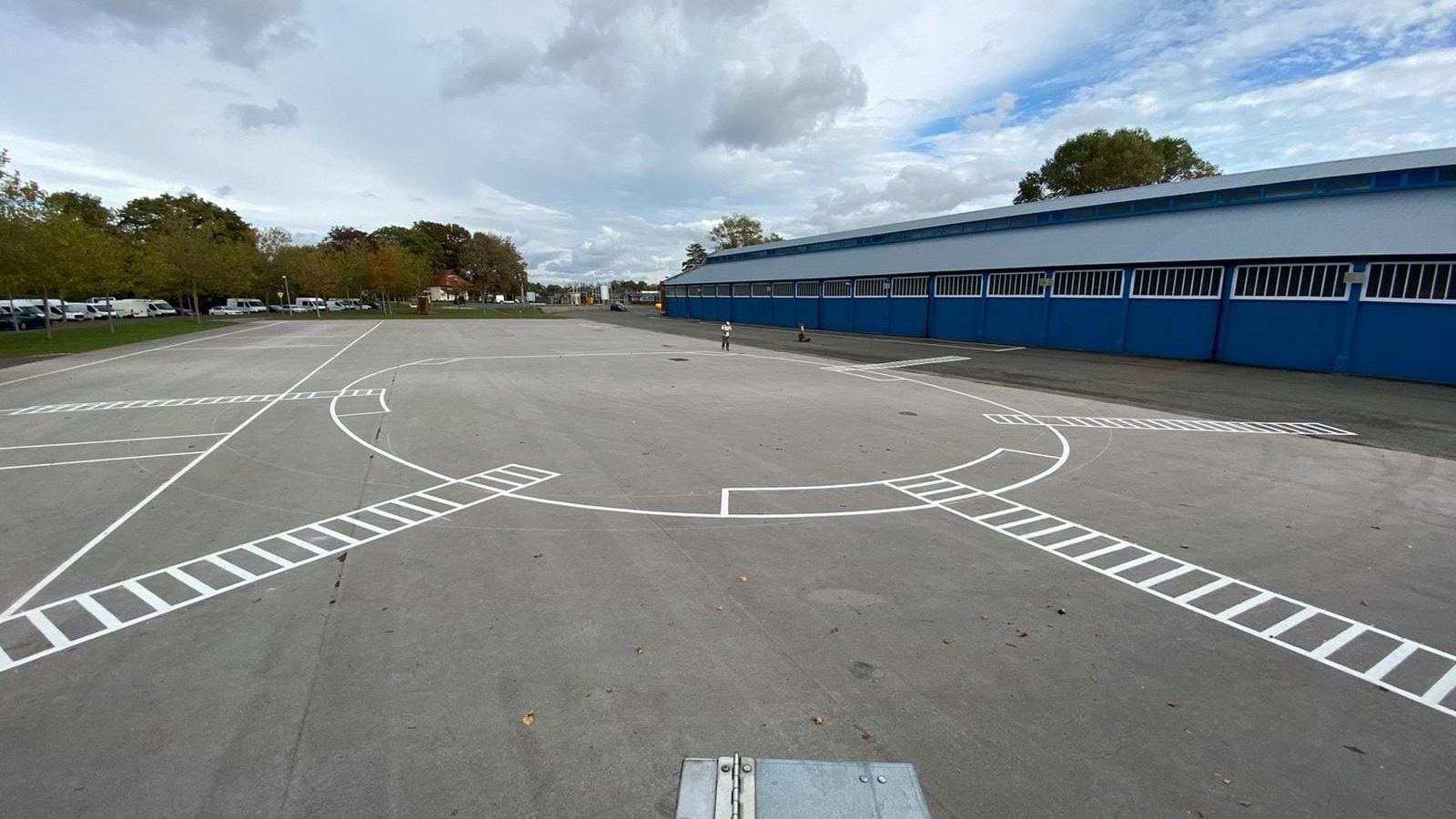 Freshly painted car park lining with clear white lines and directional markings in a large outdoor parking area, completed by Bournemouth White Lining for professional white lining services