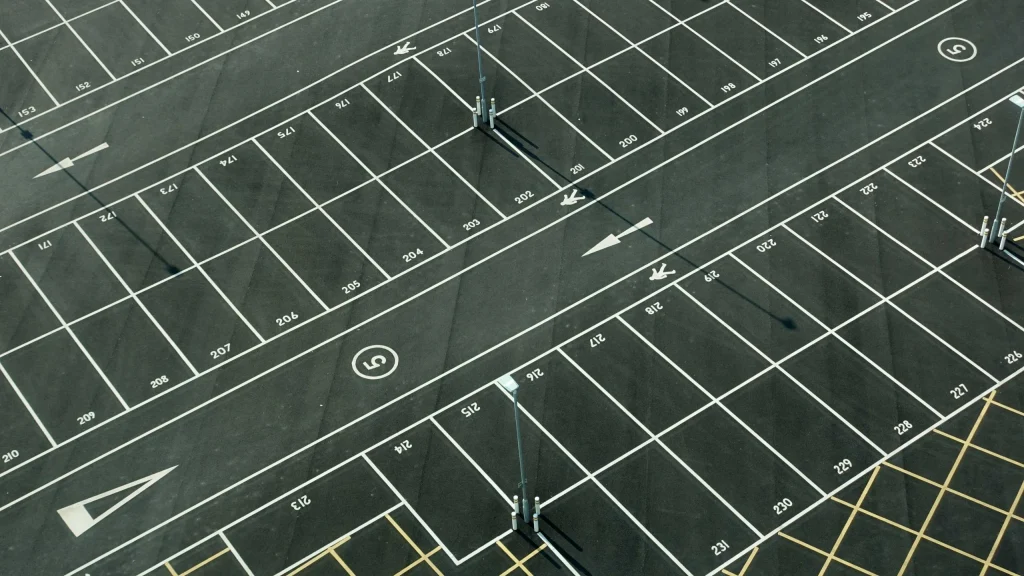 Freshly painted car park lining showing numbered parking spaces and directional arrows for organized vehicle arrangement